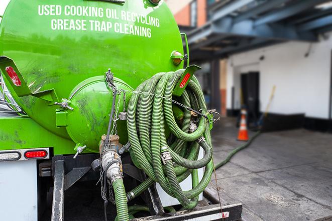 a grease trap being pumped by a sanitation technician in Newcastle WA